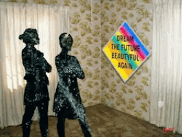 a sign that says " cream the future beautiful again " hangs on a wall