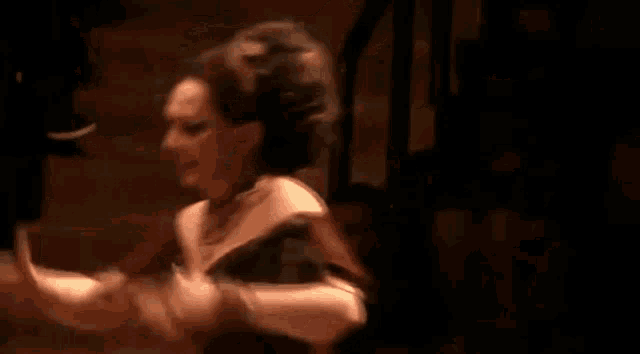 a woman is hugging a man on a stage in a theater .