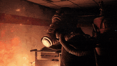 a person wearing a gas mask in a room with fire