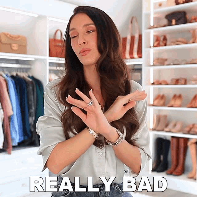 a woman says really bad in front of a closet full of clothes