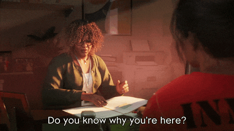 a woman sitting at a desk talking to another woman with the words " do you know why you 're here "