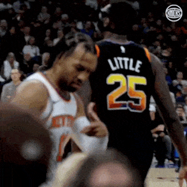 a basketball player wearing a number 25 jersey is talking to another player .