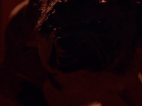 a close up of a person 's face with a dark background