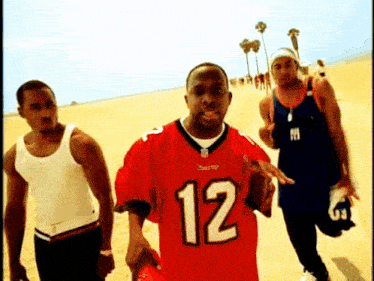 a man in a red jersey with the number 12 on the front