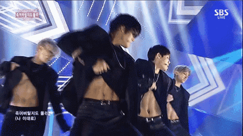 a group of men are dancing on a stage with sbs live written on the bottom