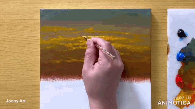 a person is painting on a canvas with the words made in animatica on the bottom right