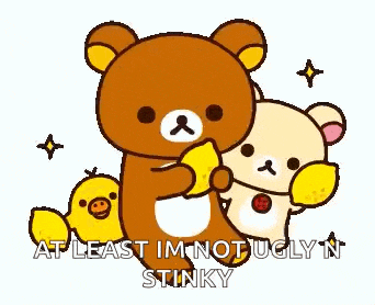 a couple of teddy bears are standing next to each other and one of them is holding a piece of lemon .