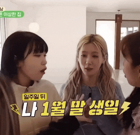 three girls are talking to each other in a room with chinese writing on the walls