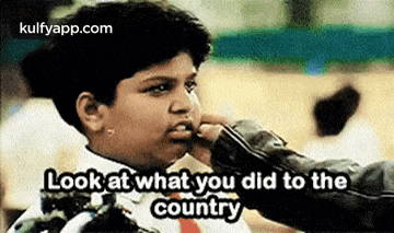 a young boy is being punched in the face by a person .