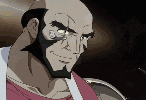 a bald man with a beard is smiling and looking at something
