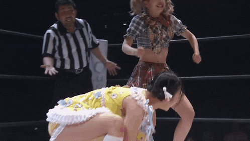 a woman in a yellow dress is kneeling down while a referee looks on