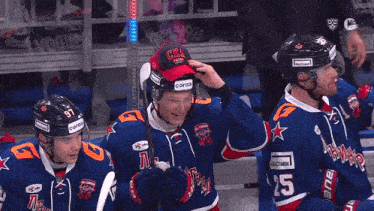a hockey player wearing a helmet that says cora3 on it