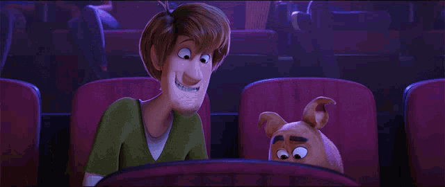 scooby doo and shaggy are sitting next to each other in a theater