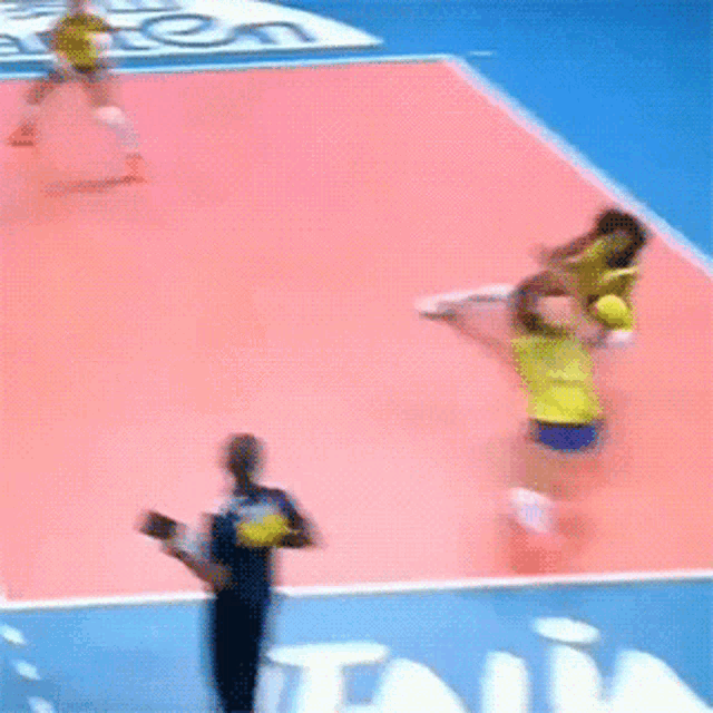 a volleyball game is being played on a court with a sign that says tna