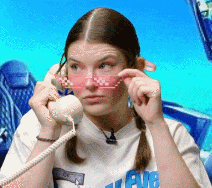 a woman wearing pink glasses is talking on a phone