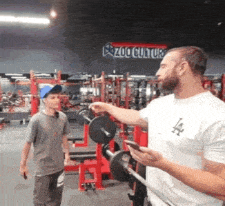 a zoo culture sign can be seen in the background of this gym