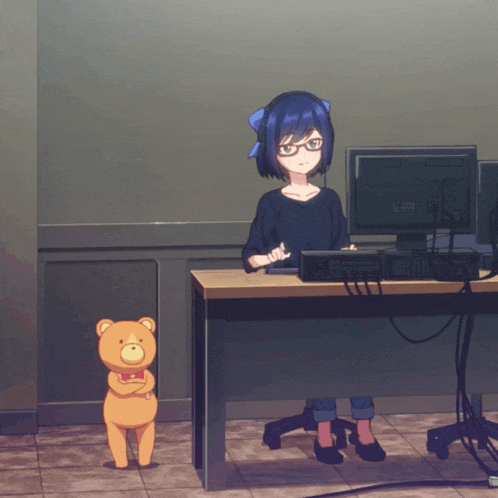 a girl sitting at a desk with a dell computer