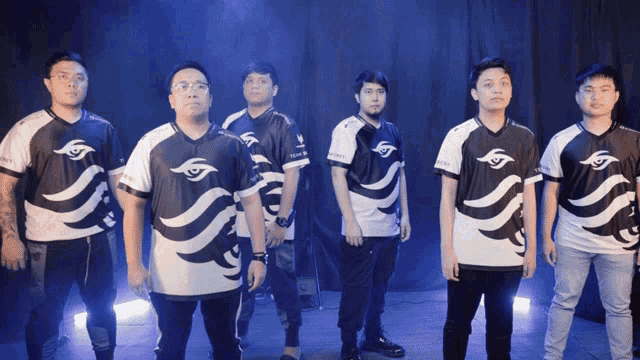 a group of men are standing in a line wearing shirts that say sg