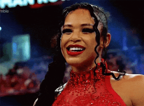 a woman in a red dress is smiling in front of a sign that says ramble