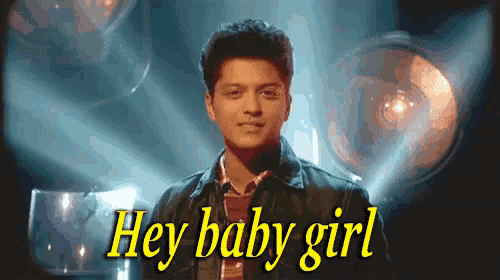 a man is standing in front of a spotlight with the words hey baby girl above him