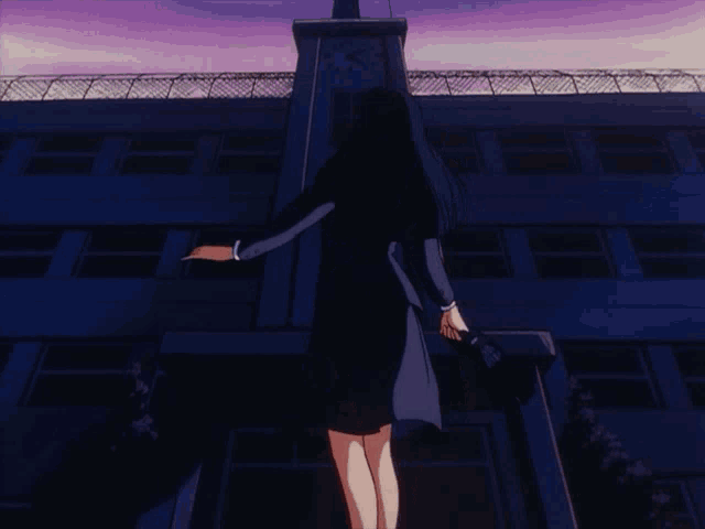a girl standing in front of a building with a clock on top of it