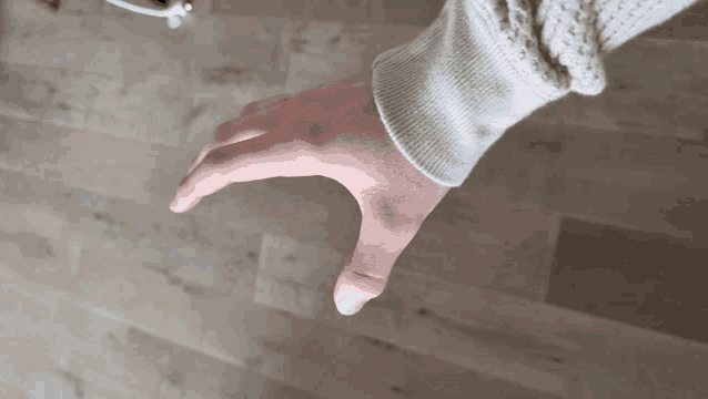 a person 's arm is shown with their thumb pointing up