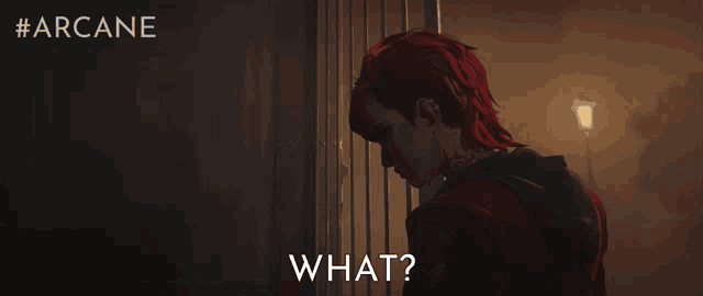 a man with red hair is standing in front of a door with the words what on it