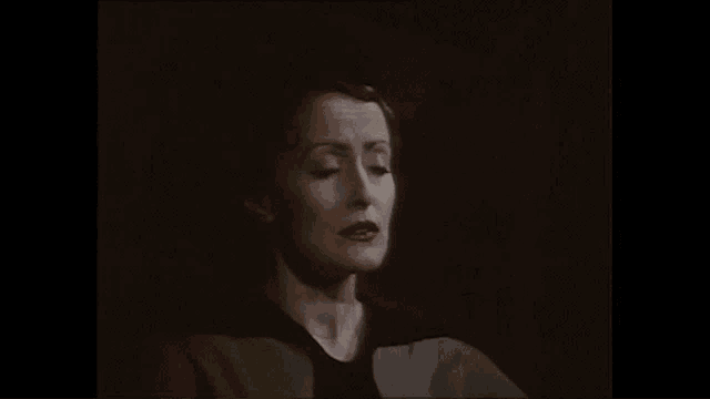a woman says is there anybody there in a dark room