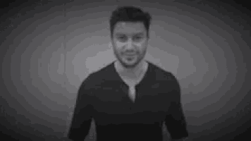 a black and white photo of a person 's shadow on a wall .