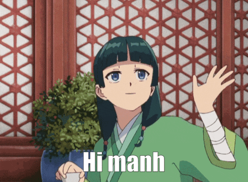 a girl in a green kimono says hi manh while waving her hand