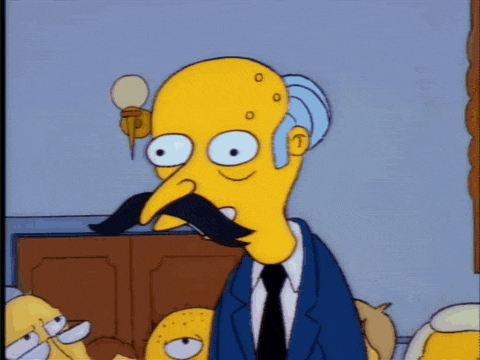 a yellow cartoon character with a mustache and glasses is wearing a blue suit and tie