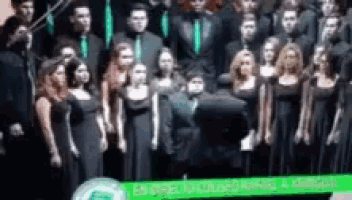 a group of people in black dresses are posing for a picture together .