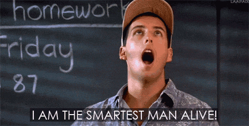 a man is standing in front of a blackboard and says i am the smartest man alive .