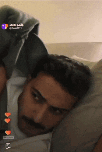 a man with a mustache is laying on a bed with the name jaco on the bottom left