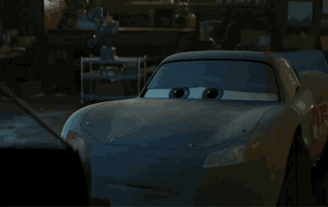 a lightning mcqueen car from the movie cars sits in a garage