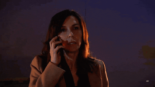 a woman is talking on a cell phone in front of a red background that says ad