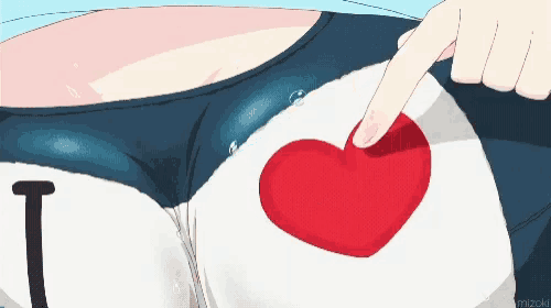 a person is pointing at a red heart on a shirt that says i love you