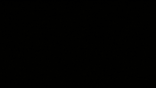 a red light is shining on a dark background