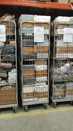 a warehouse filled with lots of boxes and carts with a sign that says ' a few boxes ' on it