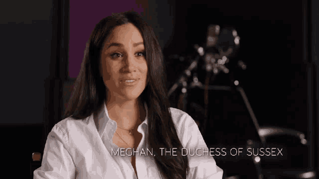 meghan the duchess of sussex is sitting in front of a camera