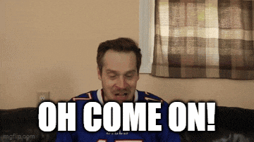 a man wearing a buffalo bills jersey is sitting on a couch and says oh come on