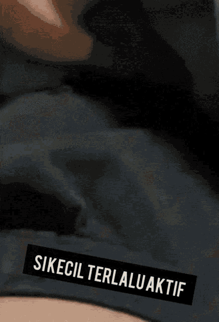 a close up of a person 's stomach with the words sikecil terlaluaktif written on it