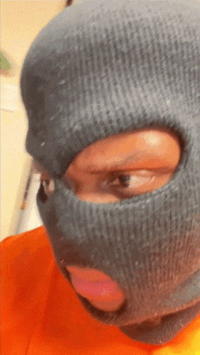 a person wearing a ski mask with a hole in the middle of the face