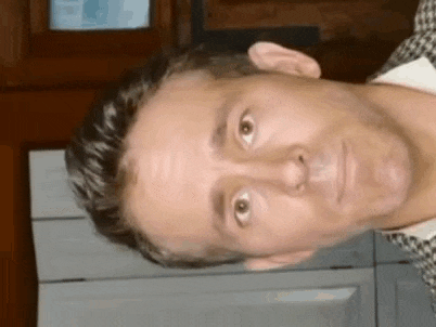 a close up of a man 's face with a funny look on his face .