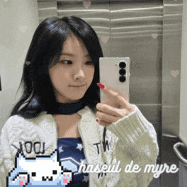 a woman taking a picture of herself in a mirror with the words haseul de myre on the bottom right