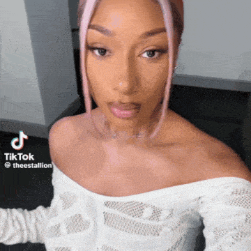 a woman is taking a selfie with a tiktok watermark