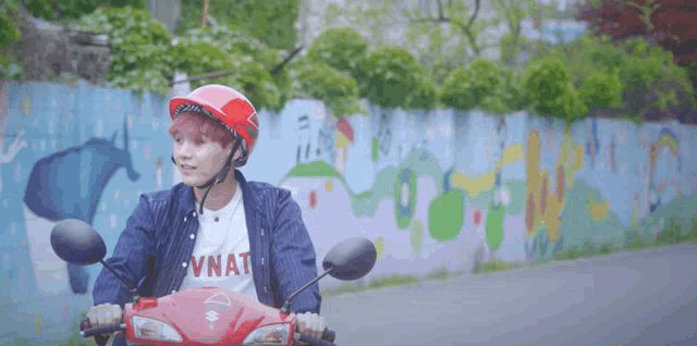 a man wearing a helmet and a shirt that says vnat