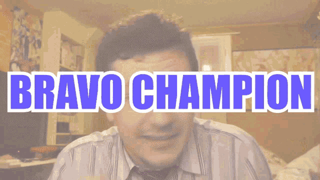 a man in a striped shirt and tie is smiling in front of a sign that says bravo champion