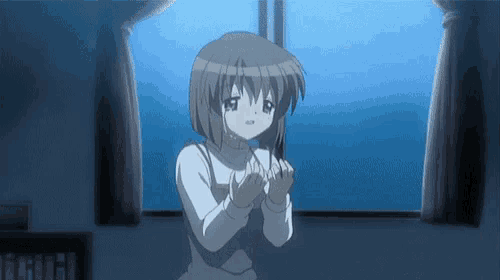 a girl with short hair is standing in front of a window with her hands folded .