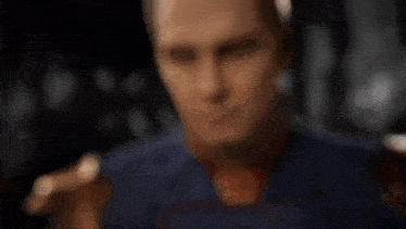 a man in a superhero costume is looking at a bottle